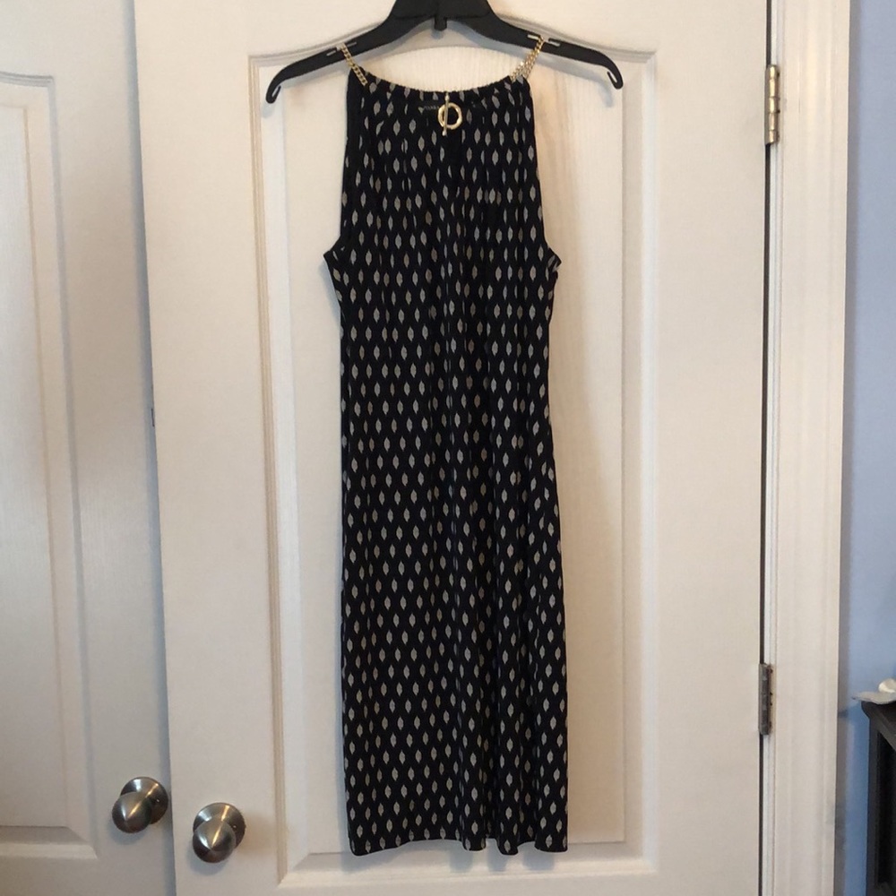 Sleeveless black dress with “gold chain” straps
